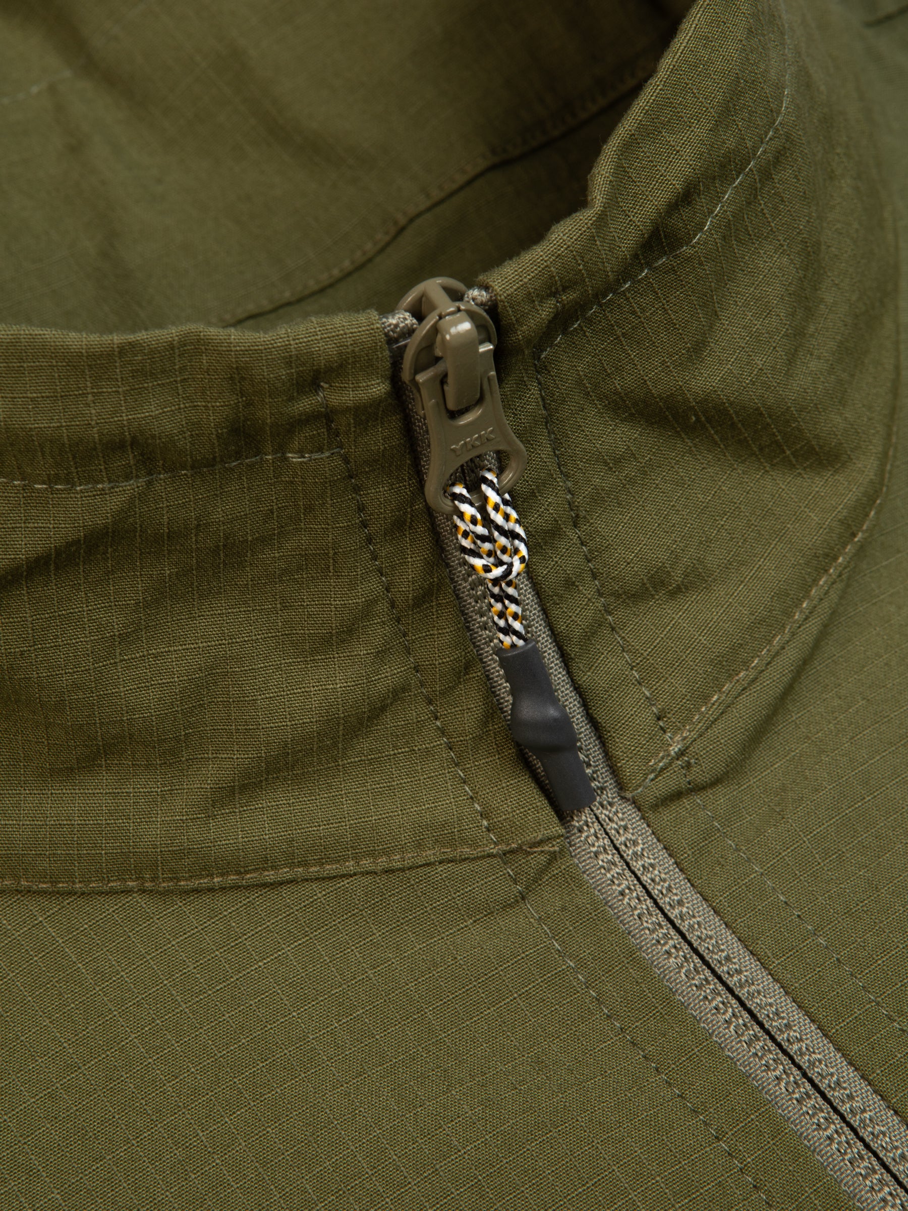 A close-up of the zippered neck of the Aberfeldy Windbreaker by designer clothing brand KESTIN.