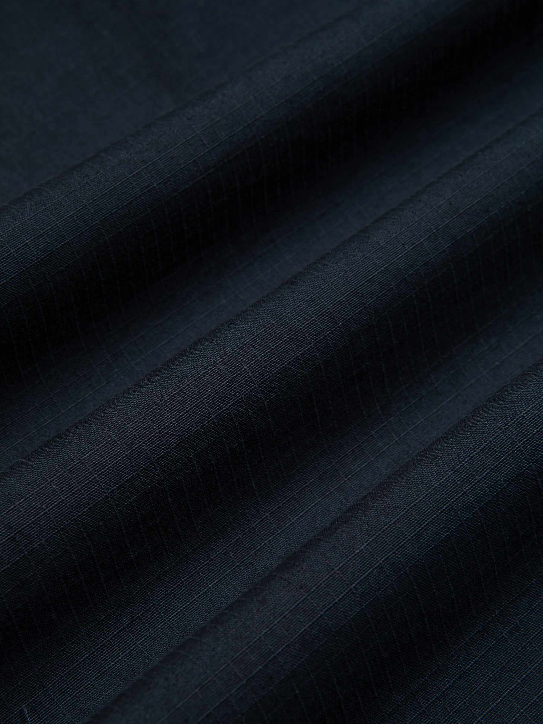 A navy blue cotton ripstop fabric used to make the KESTIN Aberfeldy Windbreaker.