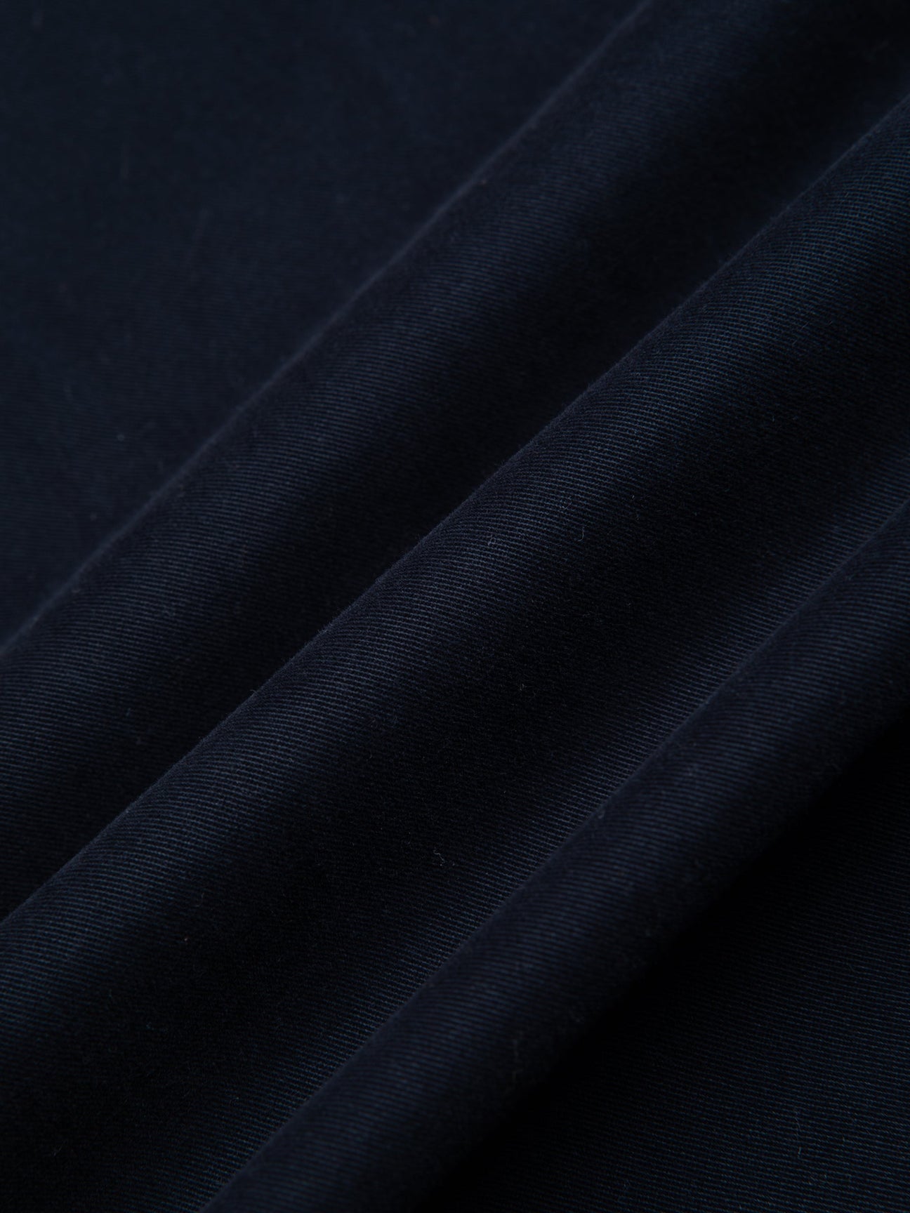 A dark navy blue twill fabric, used to make trousers by menswear brand KESTIN.