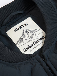 A woven KESTIN Outdoor Garments neck label, on the inside of an insulated gilet.