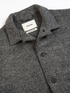 A grey Italian wool jacket from KESTIN on a white background, with the top button undone.