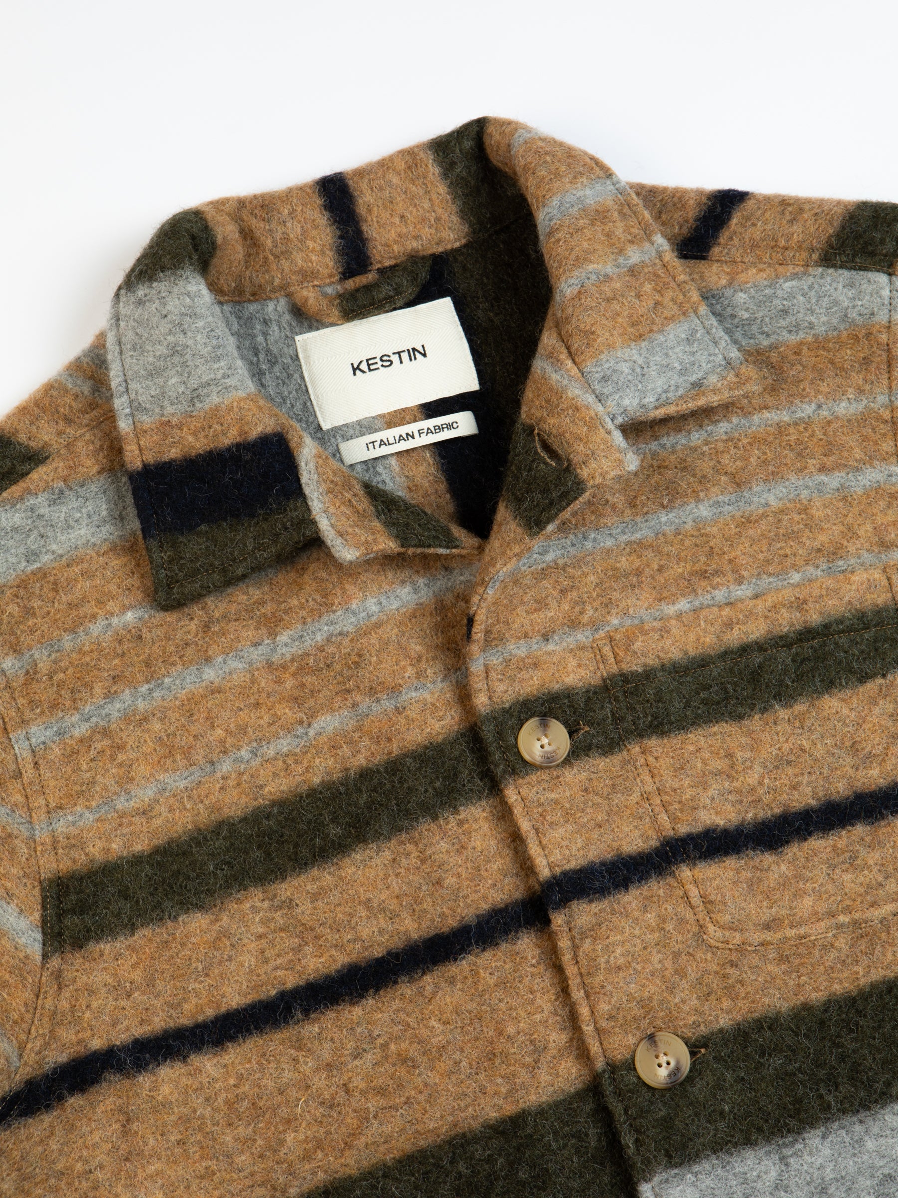 The collar and buttons of the KESTIN Ormiston Jacket in a brown stripe fabric.