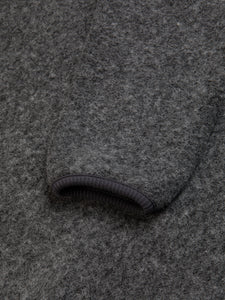 The elasticated cuff of the KESTIN Junction Sweat in grey wool.