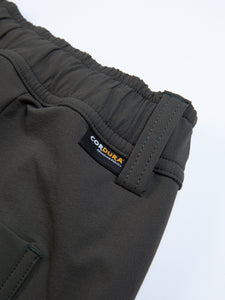 A woven CORDURA logo tag sewn to the back of the KESTIN Clyde Pant in Slate grey.