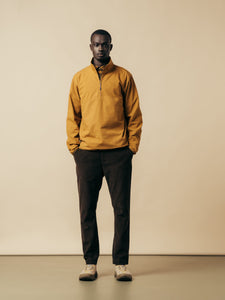 A man wearing a yellow pullover jacket from menswear designer KESTIN.