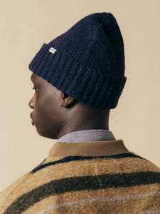 A model wearing the Balloch Beanie in Navy Blue from KESTIN