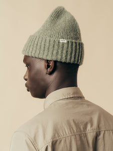 A model wearing the Balloch Beanie in Moss Green by KESTIN