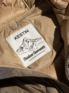 The KESTIN Outdoor Garments neck label to the inside of a green down jacket.