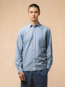 A model wearing a shirt and trousers from premium menswear brand KESTIN.