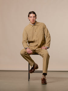 A casual men's suiting idea, with a tan corduroy chore coat and straight fit trousers.