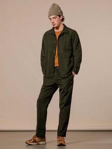 A model wearing the KESTIN Huntly Suit in an olive green corduroy material.