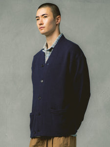 A man wearing a knitted navy blue cardigan from menswear designer KESTIN.