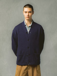 A model wearing a navy blue cardigan from premium menswear designer KESTIN.