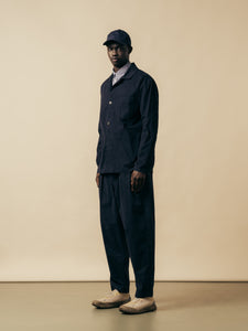 A model wearing a navy blue suit from menswear designer KESTIN.