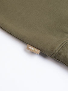 A woven logo tag to the side of the KESTIN Stobhall Sweatshirt in green.