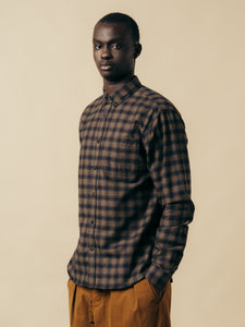 A model wearing a check long sleeve shirt from menswear brand KESTIN.