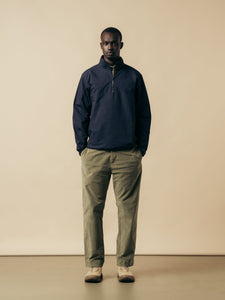 A man wearing a navy blue pullover jacket from Scottish designer KESTIN.