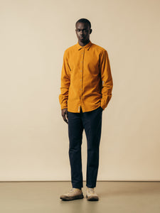 A model wearing the KESTIN Dirleton Shirt in yellow corduroy.