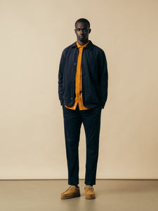 A man wearing a layered autumn outfit from menswear brand KESTIN.