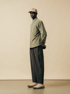 A model wearing a green shirt and brown trousers from Scottish menswear brand KESTIN.