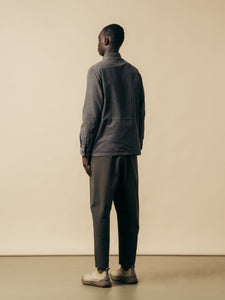 A model wearing a grey overshirt and trousers from Scottish designer brand KESTIN.