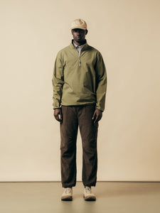 A model wearing a pullover jacket in green from menswear brand KESTIN.