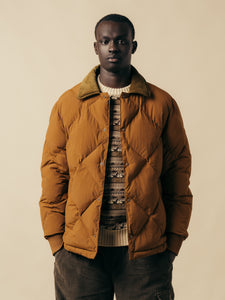 A model wearing an insulated jacket and knitted sweater from KESTIN.