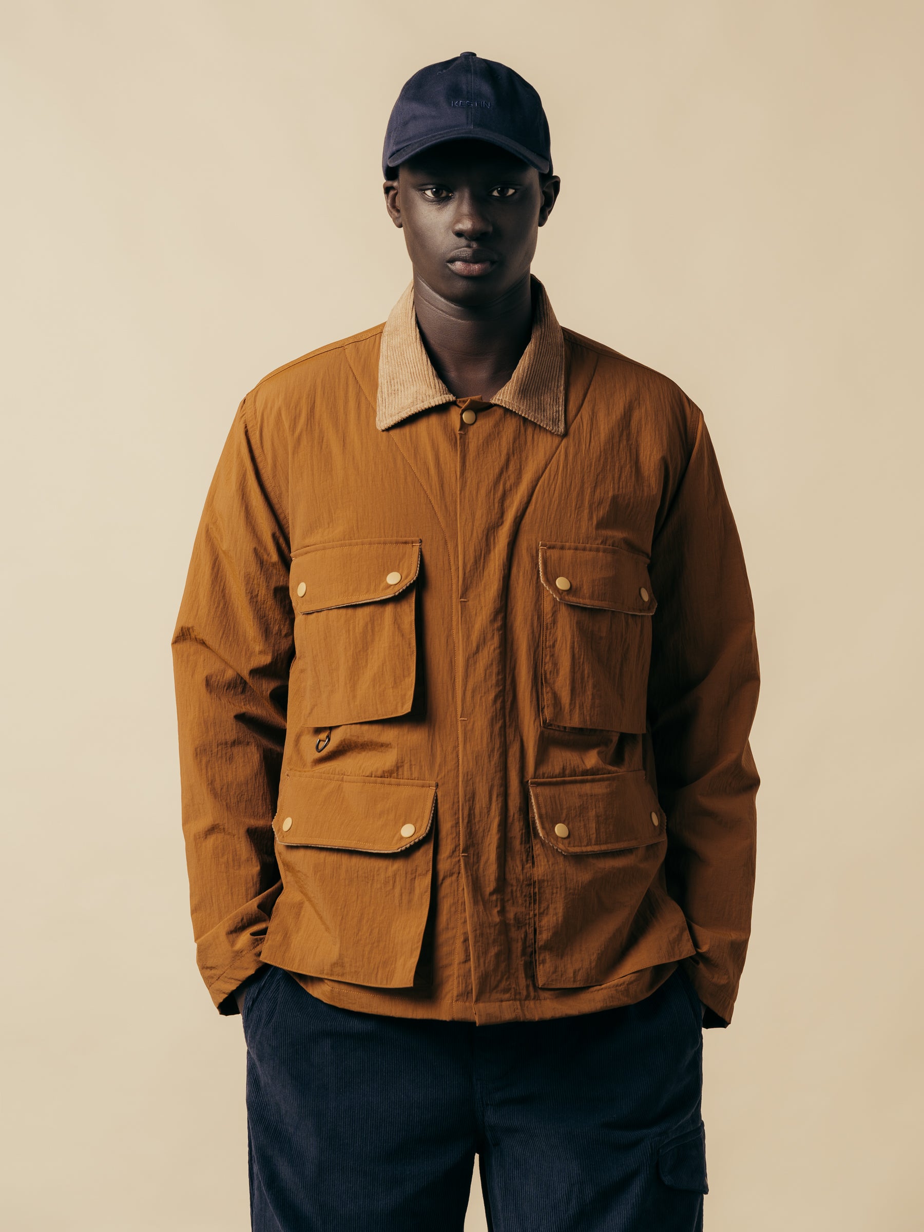 A model wearing a brown vintage jacket with four large pockets.