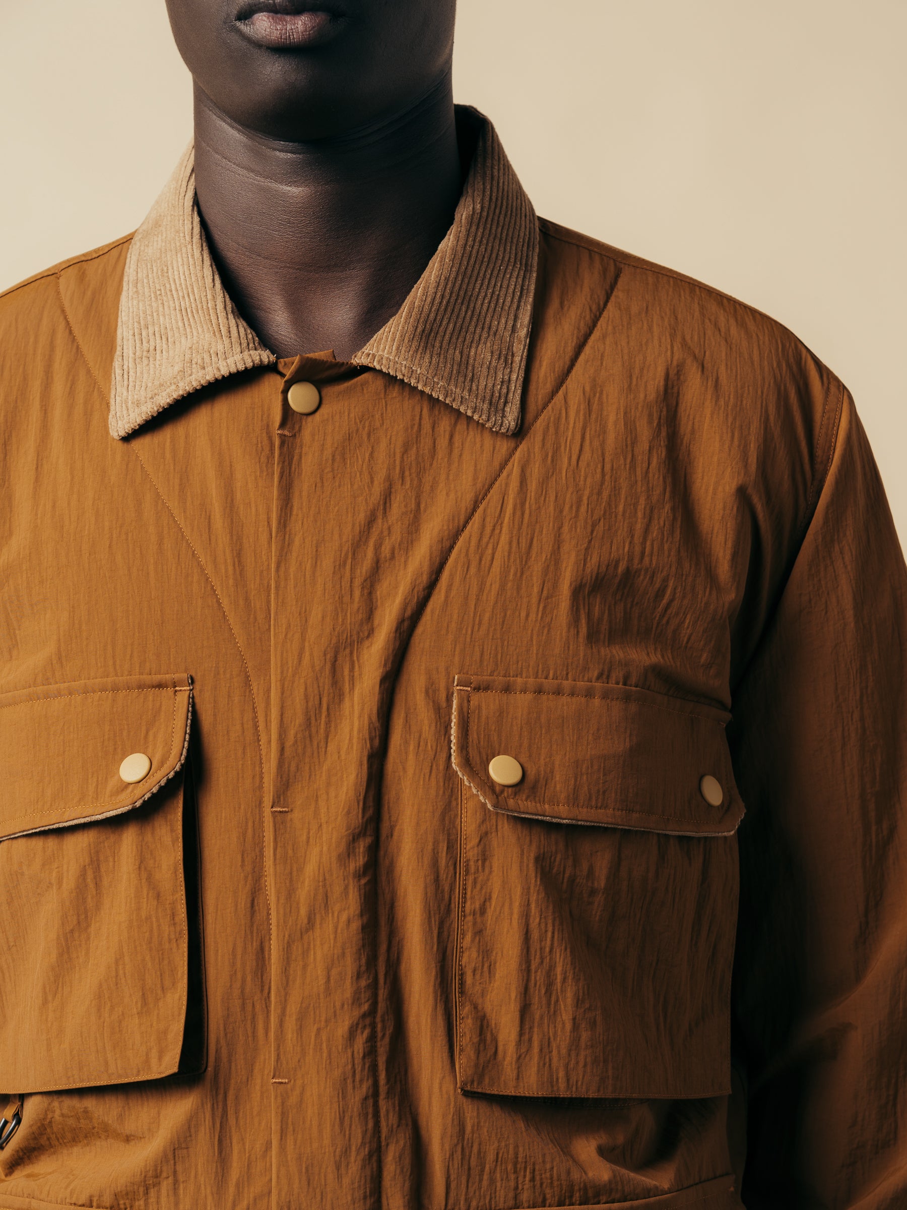 A brown jacket inspired by old country attire with a corduroy collar.