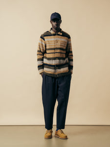 A model wearing a stripe wool jacket and navy blue trousers from menswear brand KESTIN.