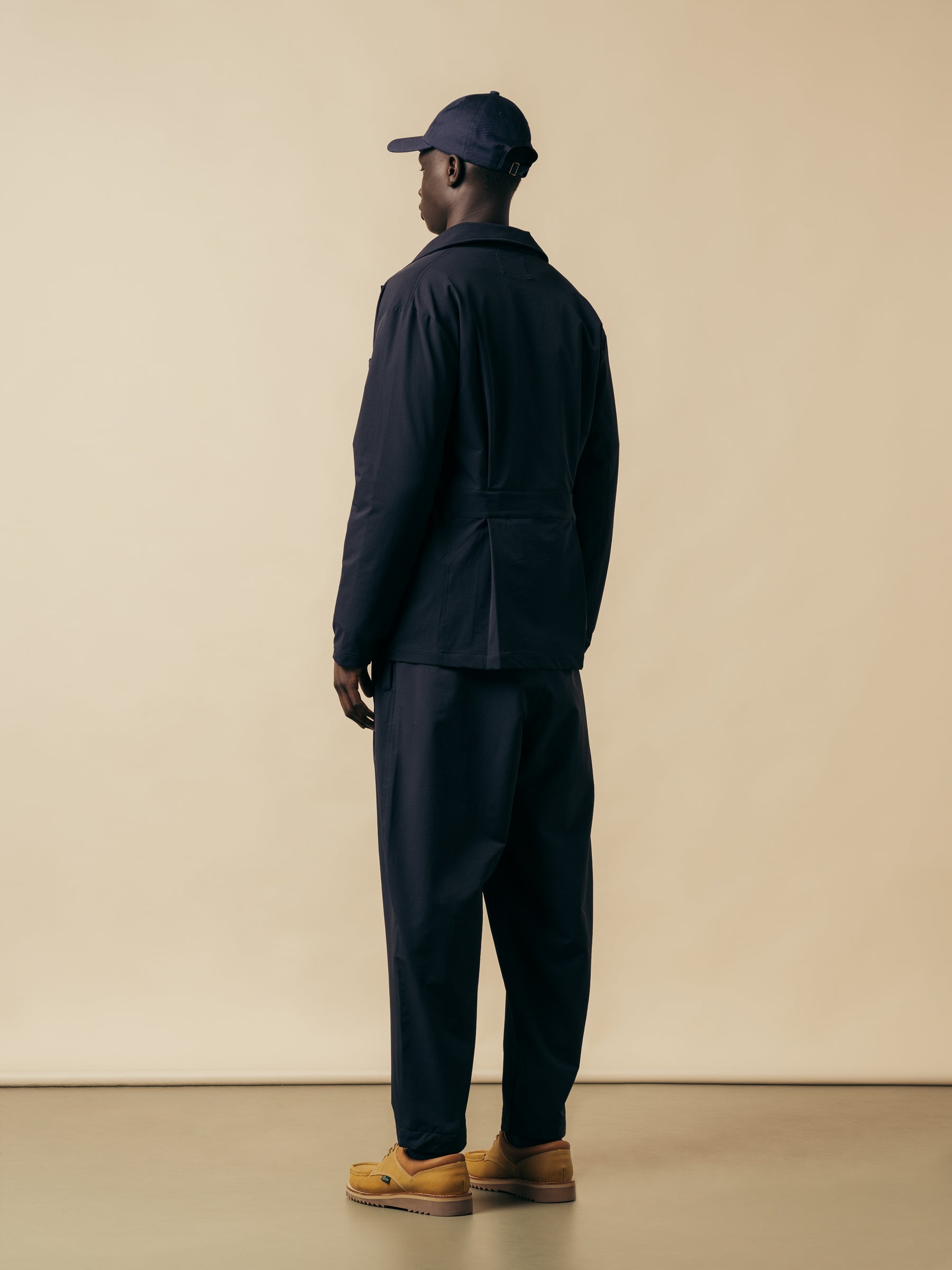 A man wearing a technical nylon navy blue suit from Scottish designer KESTIN.