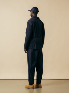 A model wearing a navy blue suit made from a technical CORDURA fabric.