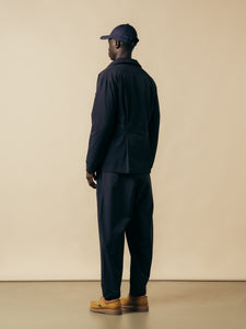 A man wearing a technical nylon navy blue suit from Scottish designer KESTIN.