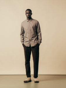 A model wearing a long sleeve shirt and slim trousers from KESTIN.