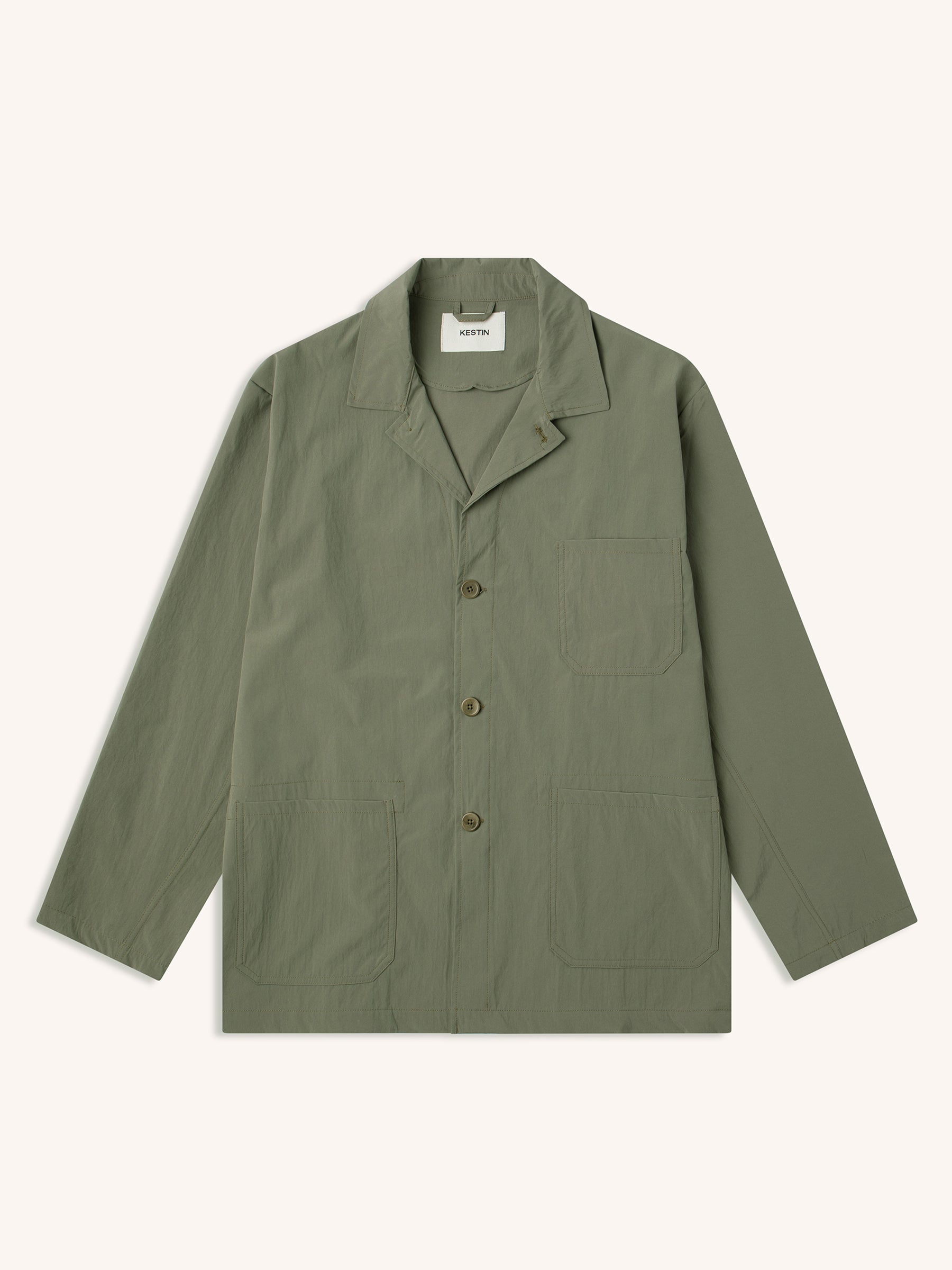 A technical olive green blazer from designer brand KESTIN, on a white background.