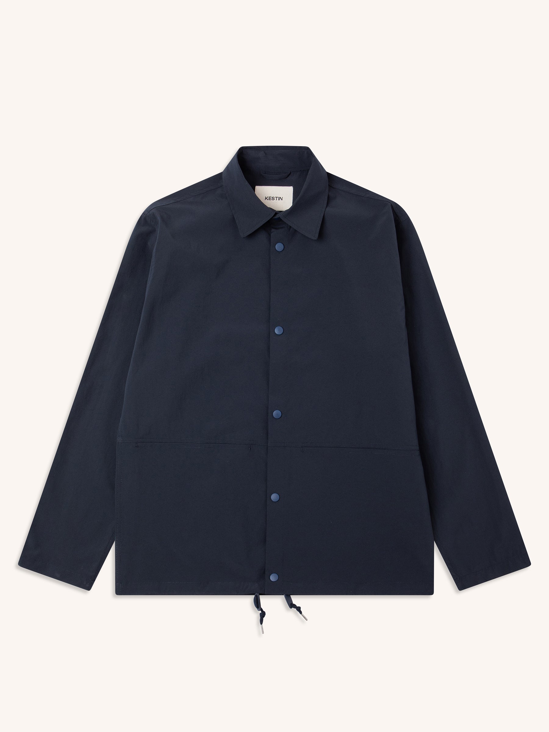 A navy blue coach jacket from KESTIN, made from temperature regulating fabric.