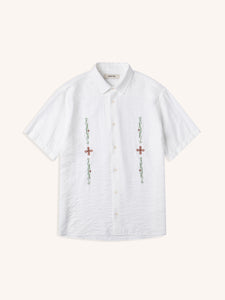 A short sleeve men's shirt in white, with embroidered celtic artwork to the front.