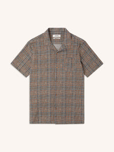 A short sleeve shirt with an olive green check pattern, on a white background.