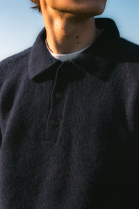 A close-up of the Lewis Shetland Polo's collar, worn on a model.