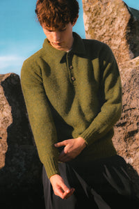 A model adjusting the cuff of the KESTIN Lewis Shetland Wool Polo Sweater.