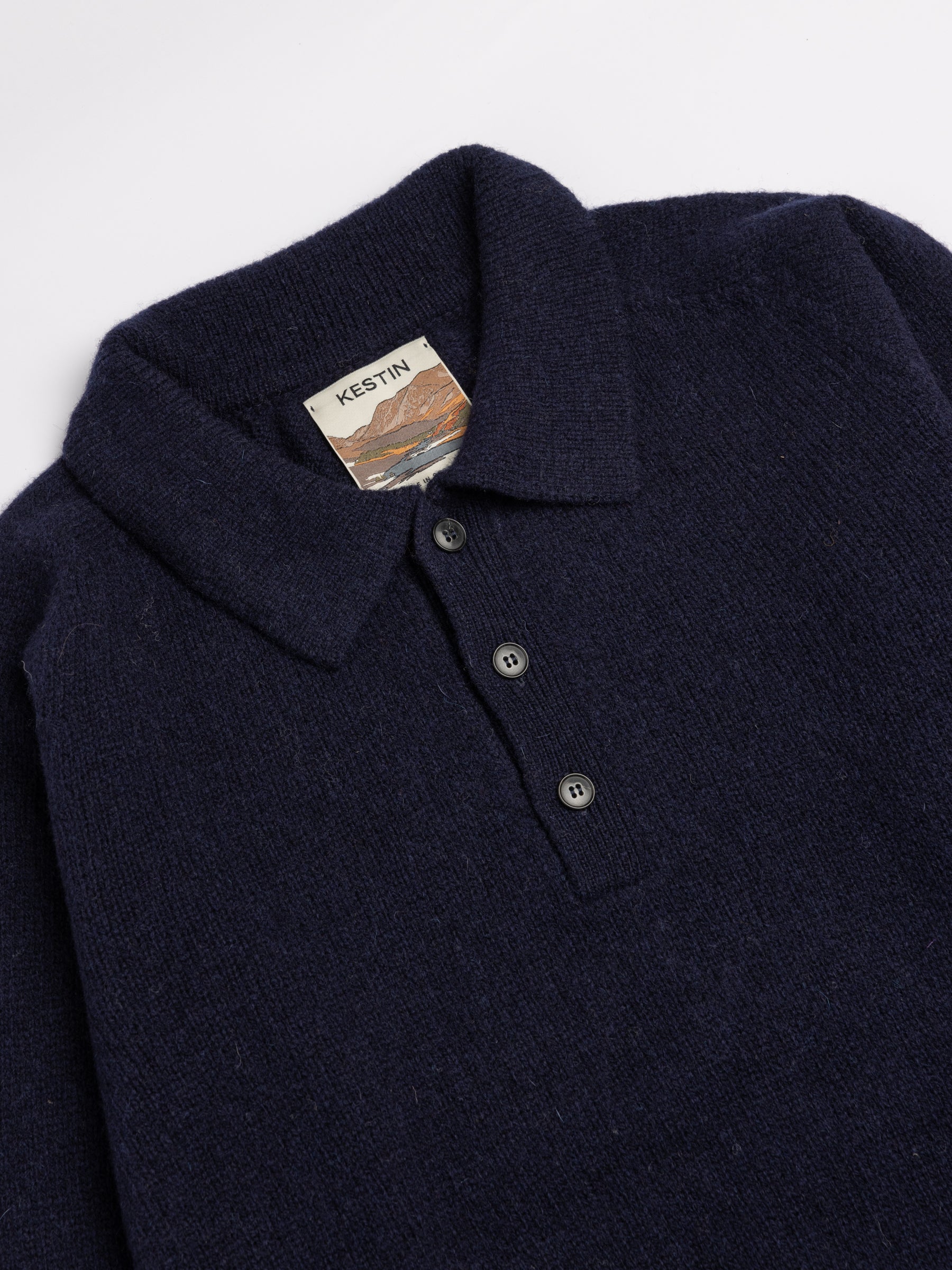 A close-up of the collar and neck of the KESTIN Lewis Shetland Polo Sweater.