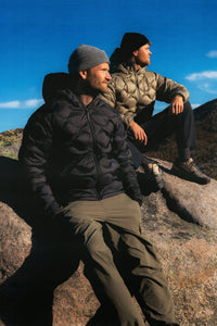 Two men on top of a mountain, wearing down jackets from KESTIN.