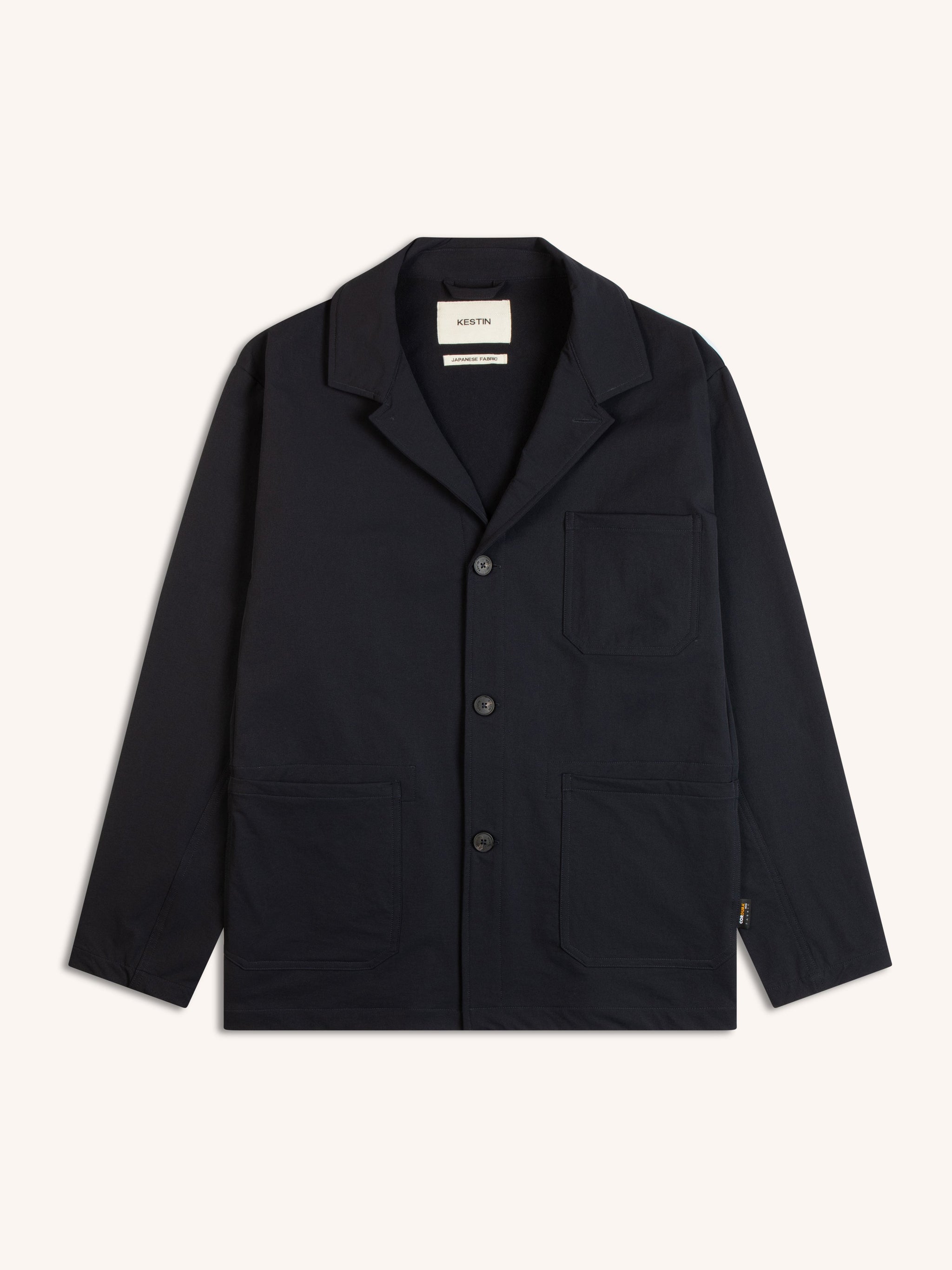 A technical nylon blazer in a dark navy blue, on a white background.