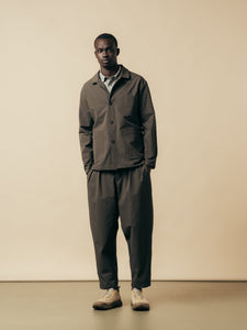 A man wearing a grey suit made from a technical CORDURA stretch fabric.