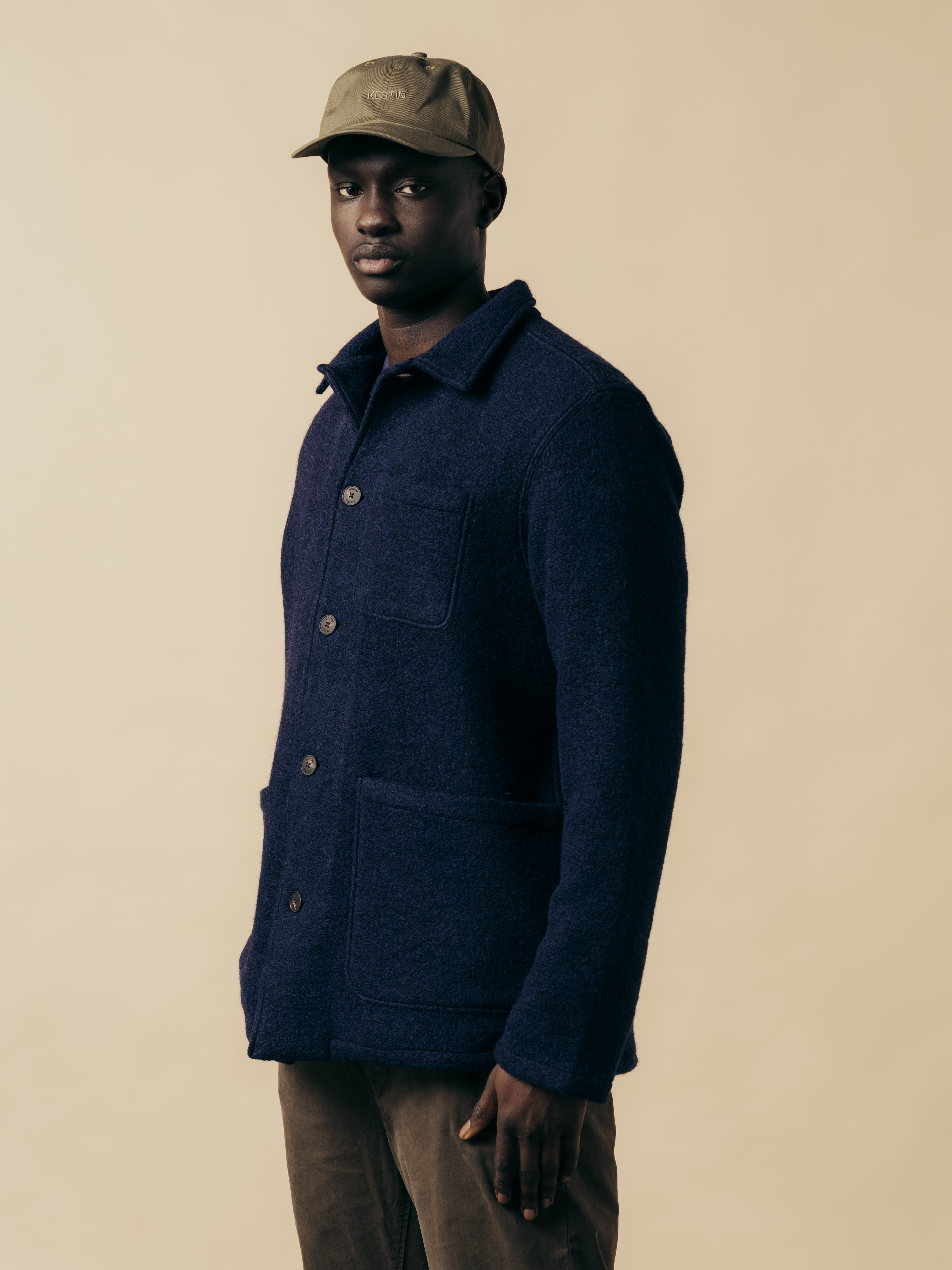 A model wearing a dark blue jacket, made from Italian wool fleece.