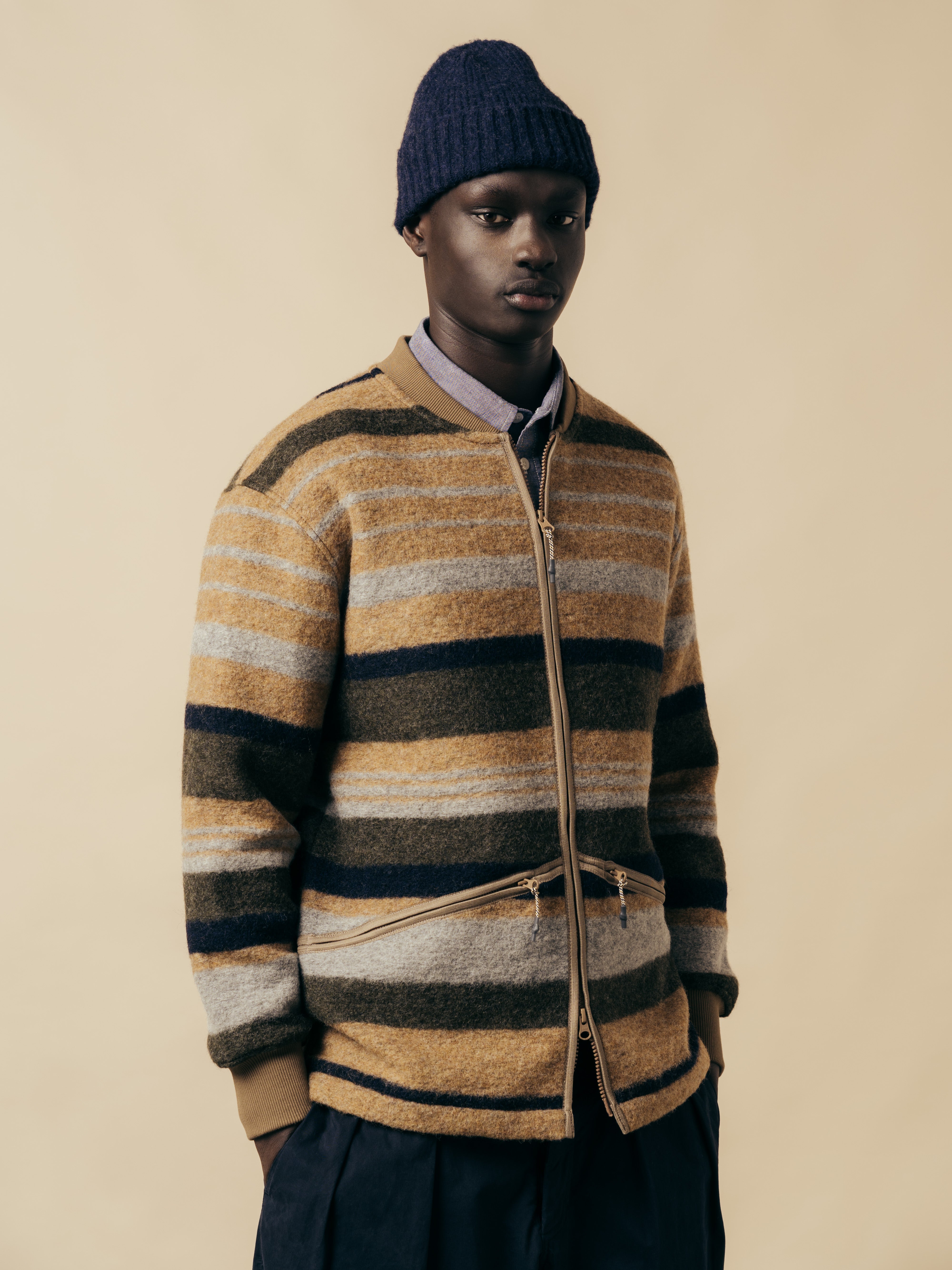 A man wearing a stripe fleece from Scottish menswear designer KESTIN, made from wool.