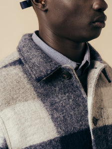 A model wearing a shirt and wool jacket from menswear brand KESTIN.