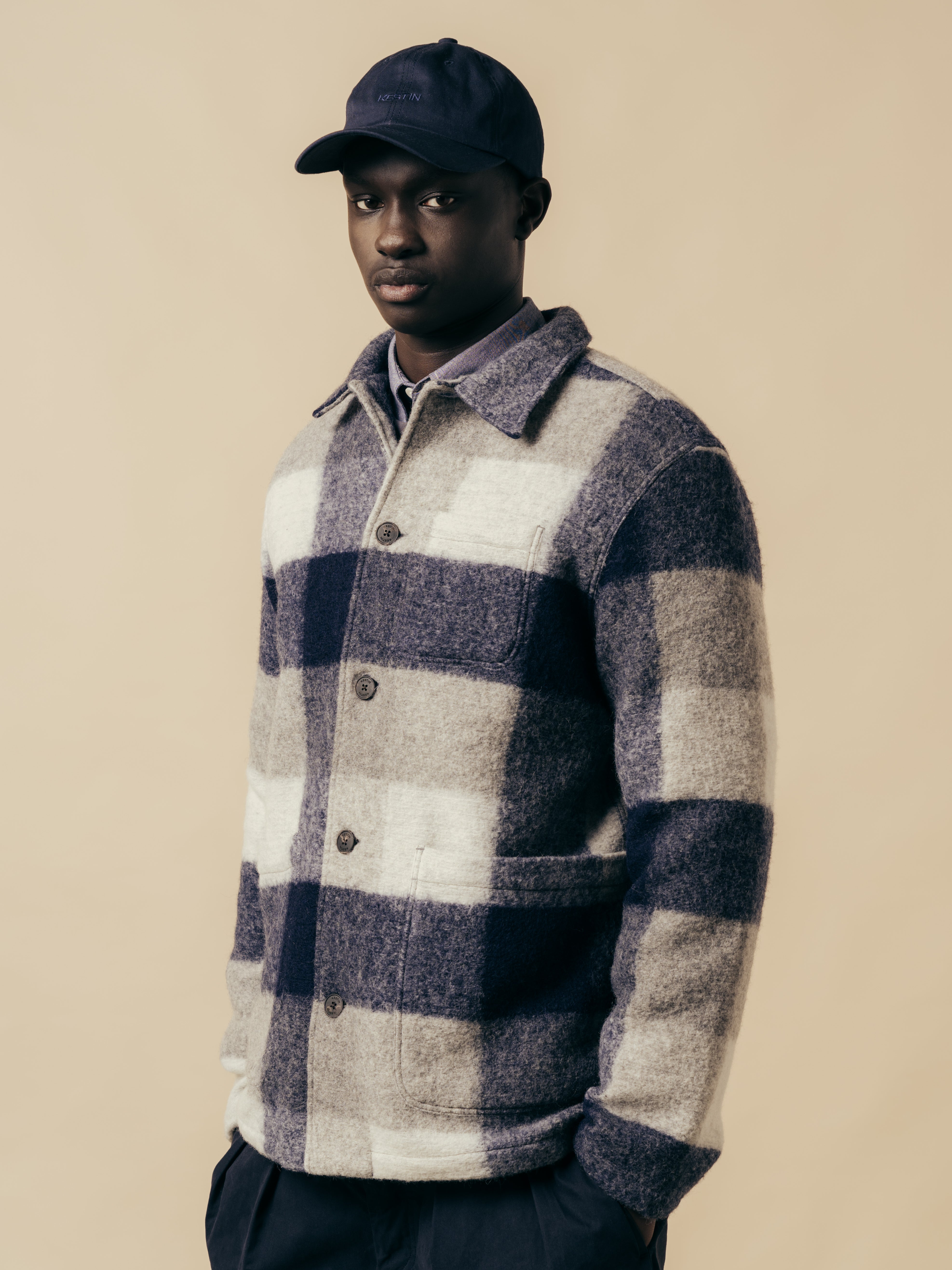 A model wearing a blue check wool fleece from Scottish menswear brand KESTIN.