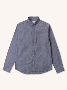 A long sleeve shirt from menswear brand KESTIN, in a blue chambray, on a white background.