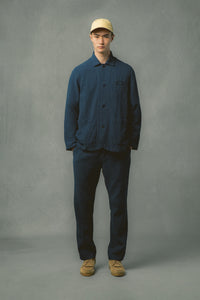 A model wearing a casual workwear-style suit in navy blue.